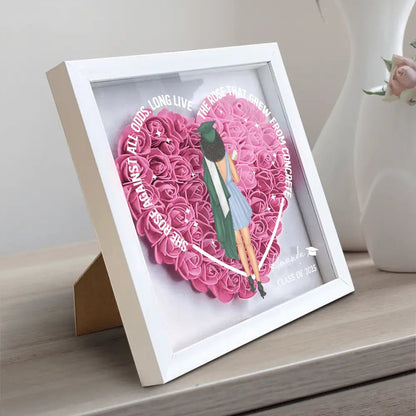 She Rose Against All Odds flower shadow box with heart-shaped pink flowers and wooden frame.